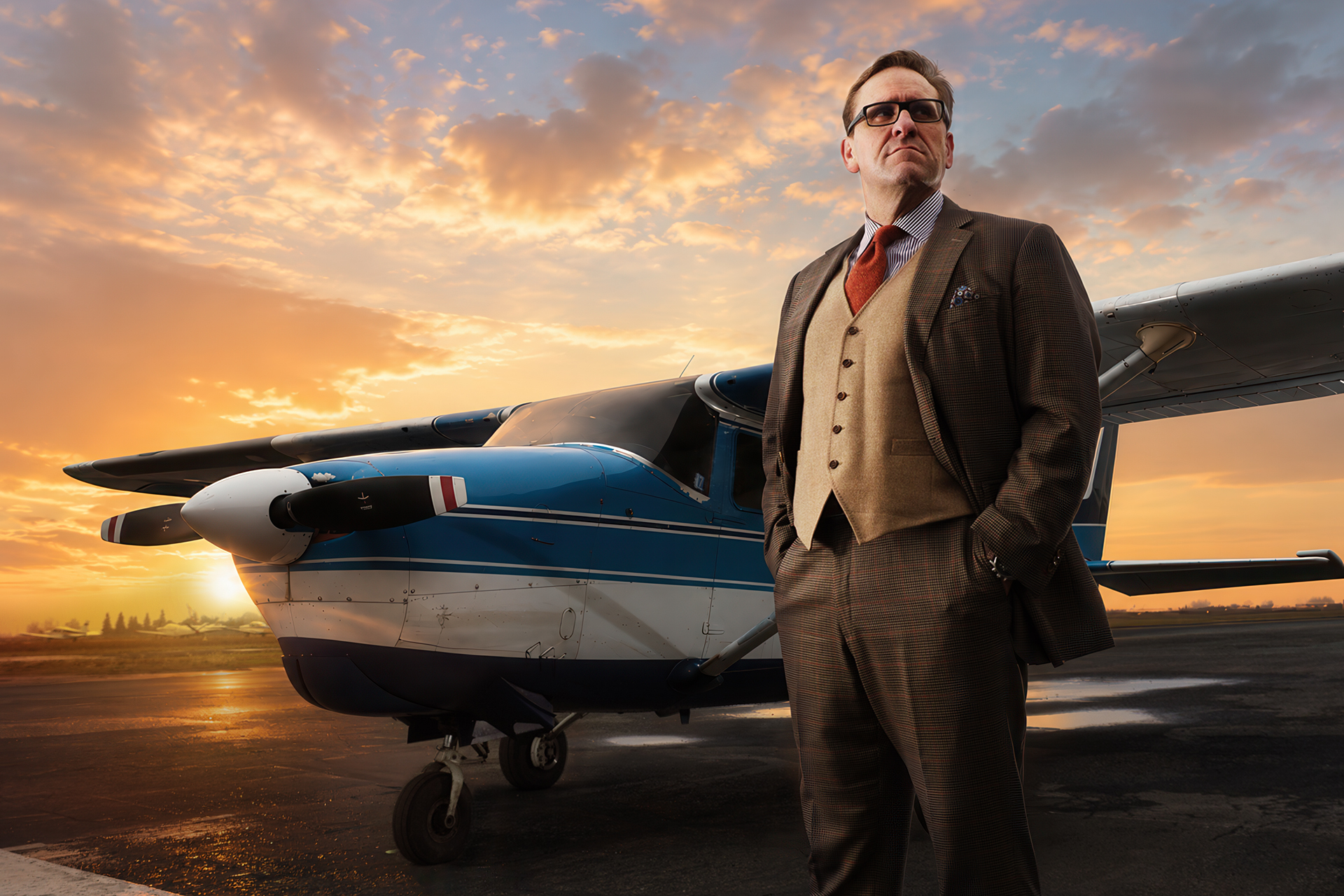 Editorial aviation portrait beside a small aircraft at sunset