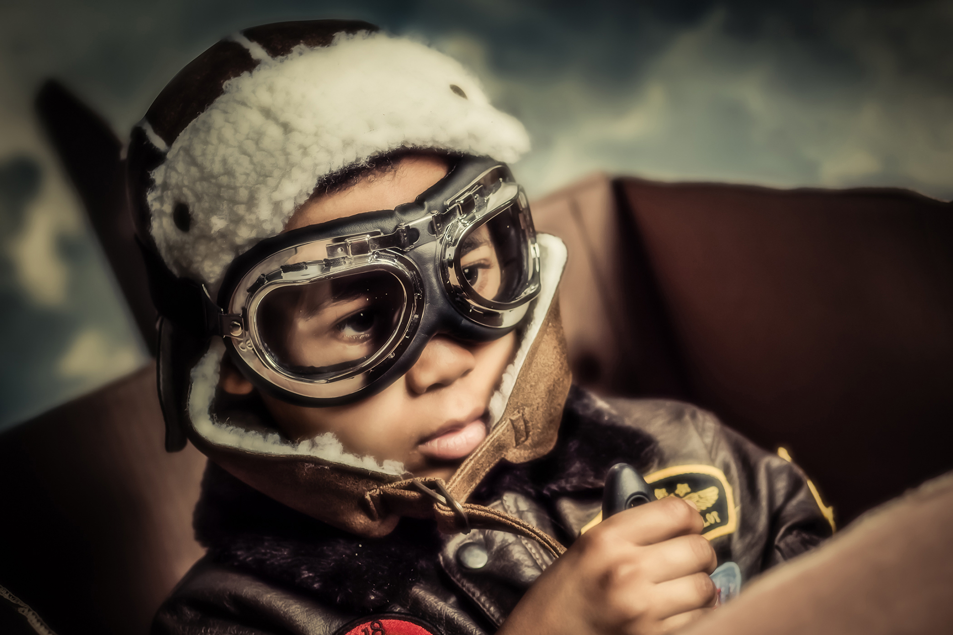 Conceptual portrait of a child dressed as an aviator