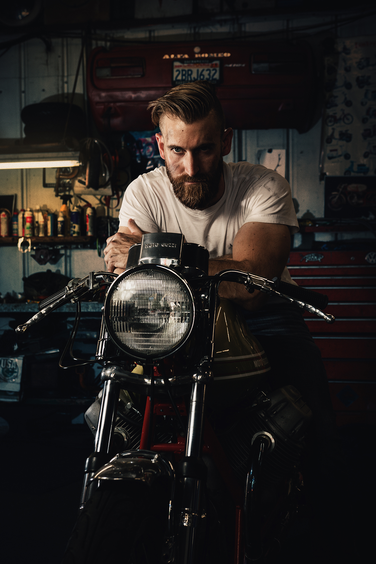 Environmental portrait of a motorcycle builder in a workshop